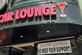 A banner asking for support hangs outside the Sam's Cable Car Lounge near Union Square, San Francisco, June 21, 2023.