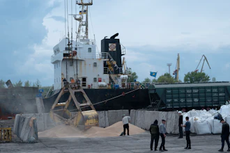 Workers load grain at a port in Izmail, Ukraine, April 26, 2023.