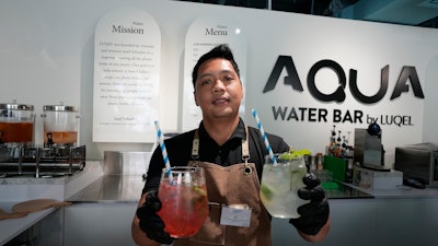 JC, mixologist, presents two types of gourmet water cocktails at the AQUA Water Bar by LUQEL, Dubai, July 11, 2023.