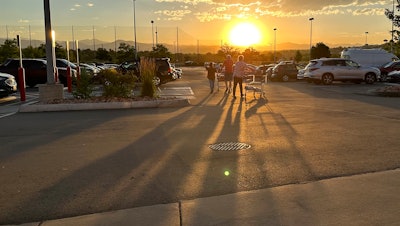Shoppers head to their cars at a Costco in Sheridan, Colo., July 11, 2023.