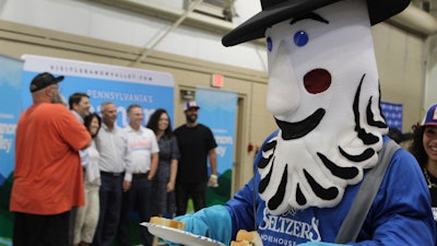 A Seltzer's mascot hands out portions of a giant bologna sandwich in Lebanon, Pa., July 25, 2023.