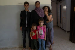 Zekriat Karram, 40, poses with her children in the West Bank city of Jenin, Aug. 3, 2023.