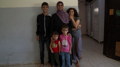 Zekriat Karram, 40, poses with her children in the West Bank city of Jenin, Aug. 3, 2023.