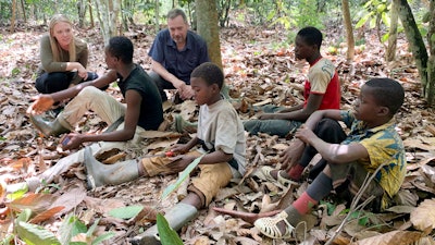 International Rights Advocates Executive Director Terrence Collingsworth and translator Melina Cardinal Bradette talk to children working on a cocoa plantation in Daloa, Ivory Coast, April 2020.