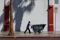 A maintenance worker pushes a cart in Las Vegas, Friday, Aug. 25, 2023.