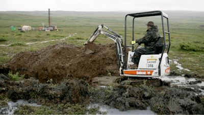 A worker with the Pebble Mine project digs in the Bristol Bay region of Alaska near the village of Iliamma, Alaska, July 13, 2007.