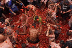 Revellers throw tomatoes at each other during the annual 'Tomatina' tomato fight fiesta, Bunol, Spain, Aug. 30, 2023.