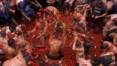 Revellers throw tomatoes at each other during the annual 'Tomatina' tomato fight fiesta, Bunol, Spain, Aug. 30, 2023.