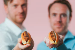 Meatable CEO Krijn de Nood, right, and CTO Daan Luining hold the company's pork sausages.