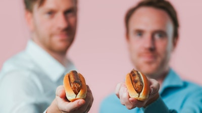 Meatable CEO Krijn de Nood, right, and CTO Daan Luining hold the company's pork sausages.