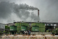 Workers seal the lid of an ethanol tank at the Bajaj Hindustan Sugar factory, Meerut, India, Aug. 23, 2023.