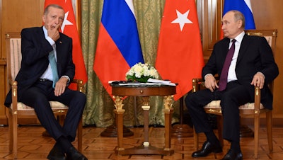 Russian President Vladimir Putin speaks to Turkish President Recep Tayyip Erdogan in Sochi, Russia, Sept. 4, 2023.