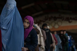 Women queue to receive cash at a money distribution site organized by the World Food Program, Kabul, Afghanistan, Nov. 20, 2021.
