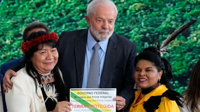 Brazil President Luiz Inacio Lula da Silva, center, Joenia Wapichana, president of the National Indigenous Foundation, left, and Minister of Indigenous Peoples Sonia Guajajara, during a ceremony in Brasilia, Sept. 5, 2023.
