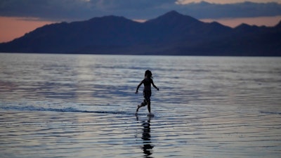 A child runs through the Great Salt Lake near Magna, Utah, June 15, 2023.