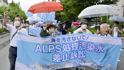 Plaintiffs and supporters march to the Fukushima District Court, Fukushima, Japan, Sept. 8, 2023.