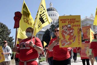Fast food workers and their supporters march past the California state Capitol in Sacramento, Aug. 16, 2022.