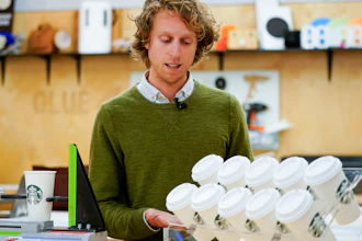 Senior packaging engineer Kyle Walker explains a tilt test for cups at the Tryer Center at Starbucks headquarters, Seattle, June 28, 2023.