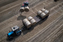 A tractor collects straw on a farm in Zhurivka, Ukraine, Aug. 10, 2023.