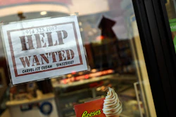 A help-wanted sign posted in a storefront in Bedford, N.Y., Nov. 1, 2022.