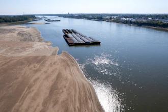 Barges float in the Mississippi River, St. Louis, Sept. 15, 2023.