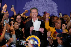 California Gov. Gavin Newsom signs the fast food bill surrounded by fast food workers at the SEIU Local 721 in Los Angeles, on Thursday, Sept. 28, 2023.