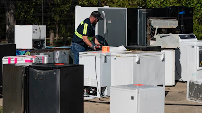 An operator attaches equipment to a used appliance at a customer recovery job site, Monday, Oct. 9, 2023, in Little Elm, Texas.
