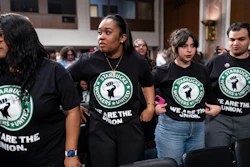 Advocates for a union for Starbucks employees watch as company founder Howard Schultz leaves a hearing at the Capitol in Washington, March 29, 2023.