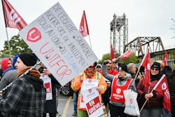 Striking workers picket outside the St. Lambert Lock in St. Lambert, Quebec, Oct. 23, 2023.