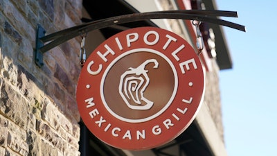 The Chipotle Mexican Grill logo hangs outside a restaurant location, Dec. 20, 2022. On Wednesday, Sept. 27, 2023, a federal agency sued the restaurant chain Chipotle, accusing it of religious harassment and retaliation after a manager at a Kansas location forcibly removed an employee's hijab, a headscarf worn by some Muslim women.