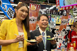 Japanese Agriculture Minister Ichiro Miyashita, right, and Malaysian celebrity Amber Chia attend an event at Japanese store, Don Don Donki in Kuala Lumpur Wednesday, Oct. 4, 2023 to promote the safety and deliciousness of Japanese scallops to shoppers. Japan hopes to resolve the issue of China's ban on its seafood within the scope of the World Trade Organization ambit and will hold food fairs overseas to bolster seafood exports amid safety concerns over the release of treated water from the Fukushima Daiichi nuclear plant, Miyashita said Wednesday.