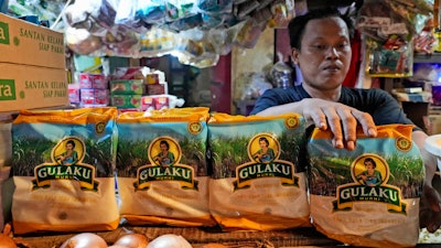 A vendor arrange packages of sugar at a market, Jakarta, Indonesia, Oct. 24, 2023.