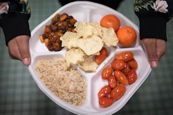A seventh grader carries her plate during lunch at a public school in Brooklyn, New York, Feb. 10, 2023.