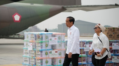 Indonesian President Joko Widodo, left, and Foreign Minister Retno Marsudi inspect relief supplies for Gaza at Halim Perdanakusuma air base, Jakarta, Nov. 4, 2023.