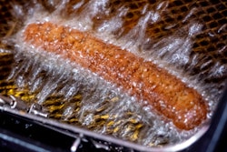 A vegan curry wurst is deep fried in a 'Best Worscht in Town' sausage branch in Frankfurt, Germany, Wednesday, Sept. 13, 2023.