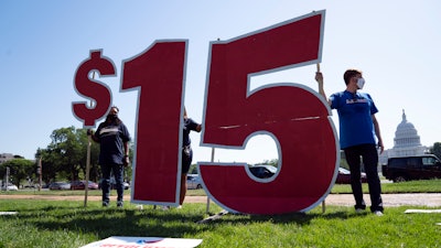 Demonstrators gather in support of McDonald's workers on strike to be paid $15 per hour in Washington on May 19, 2021.