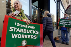 Arlene Geiger, left, holds a sign supporting Starbucks workers outside a Starbucks on New York's Upper West Side, Nov. 16, 2023.