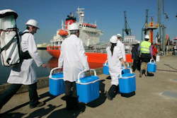 Technical personnel enter a ship loaded with drinking water, Barcelona, May 13, 2008.