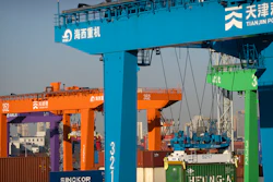 A crane lifts a shipping container at an automated container port in Tianjin, China, Jan. 16, 2023. The global economy, which has proved surprisingly resilient this year, is expected to falter next year under the strain of wars, still-elevated inflation and continued high interest rates.