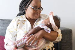 Asian Davis, 33, of Sikeston, Mo., cradles her 8-month-old daughter, Mira White during an interview on Oct. 3, 2023, in St. Louis. Davis and her lawyers say Mira suffered brain damage in March after developing bacterial meningitis tied to powdered infant formula contaminated with Cronobacter sakazakii, a germ known to cause severe disease in young babies.