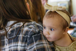 Cora Dibert, 1, is held by her mother, Morgan Shurtleff, at The Bridge Church, Mustang, Okla., Dec. 2, 2023.