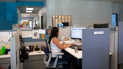 Social worker Lupita Armijo-Garcia at her desk at the Ottawa Co. Dept. of Public Health, Sept. 5, 2023, Holland, Mich.