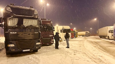 Ukrainian truck drivers wait to cross from Poland back into Ukraine, Korczowa, Poland, Dec. 7, 2023.