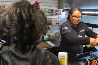 Cashier Denise Padilla rings up groceries on a mobile supermarket in Atlantic City N.J., Dec. 8, 2023.