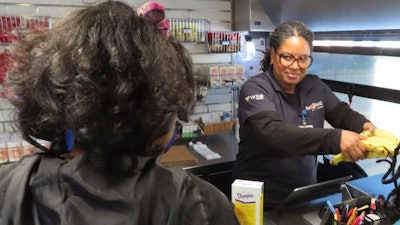 Cashier Denise Padilla rings up groceries on a mobile supermarket in Atlantic City N.J., Dec. 8, 2023.