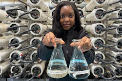 Lakeisha Bryant, public information representative at the Santa Clara Valley Water District, holds flasks of water before and after it is purified at the Silicon Valley Advance Purification Center, Dec. 13, 2023, San Jose.