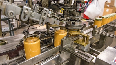 The peanut butter capper at Once Again's factory.