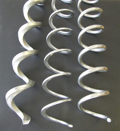 The flexible screw conveyor’s only moving part, the spiral, continuously mixes as it conveys.