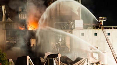 Firefighters work at the scene following an explosion and fire at the Didion Milling plant, Cambria, Wis., June 1, 2017.