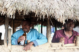 Benson Muhereza drinks tonto at a bar, Majengo village, Uganda, Dec. 10, 2023.